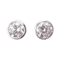 Pair of platinum bezel set round brilliant cut diamond stud earrings, hallmarked, total diamond weight approx 0.50 carat