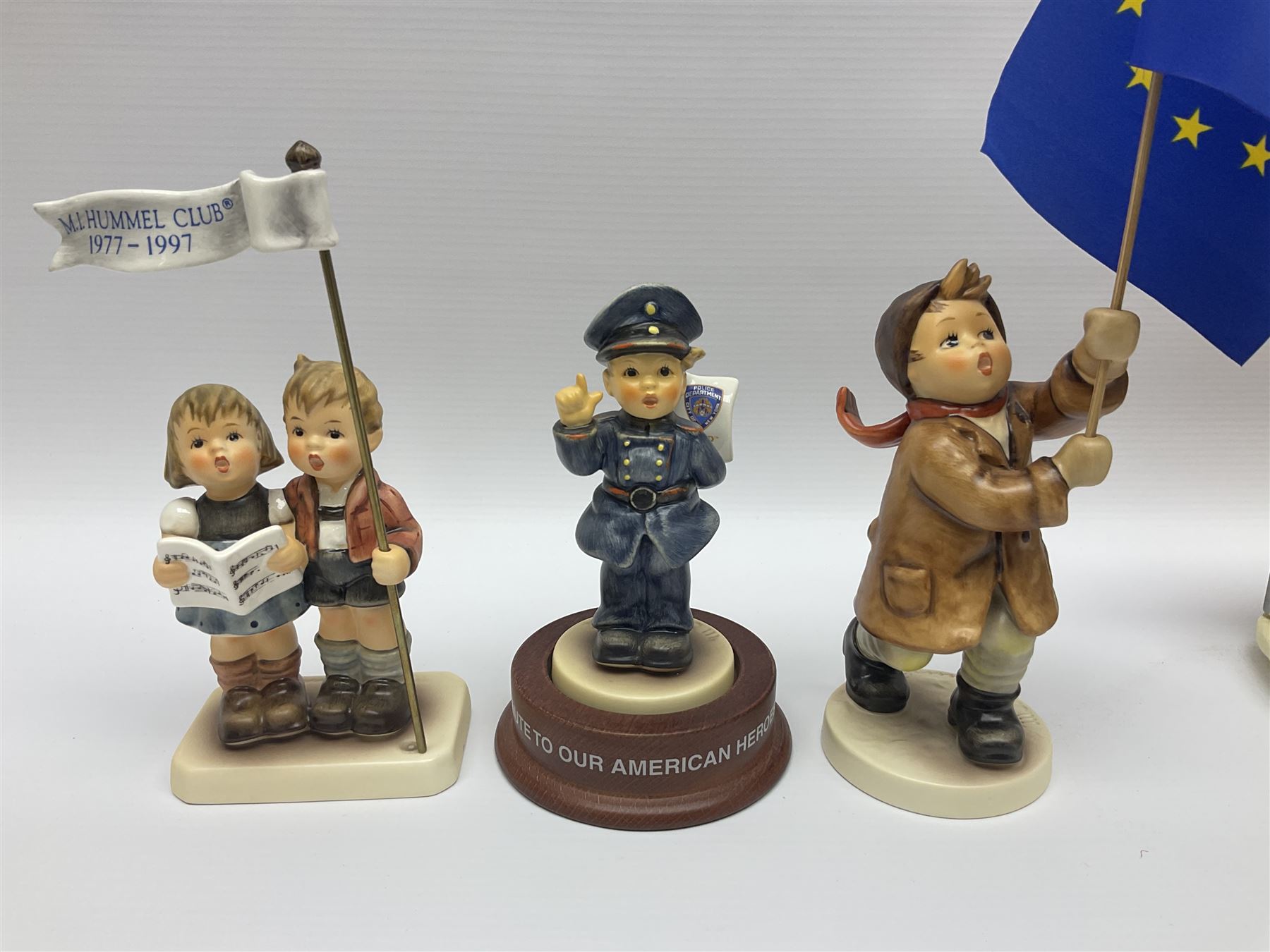 Thirty Hummel figures by Goebel, to include Saluting the Peacekeepers of Operation Joint Endeavor, on wooden plinth, Call to Glory, Celebrate with Song and Soldier Boy