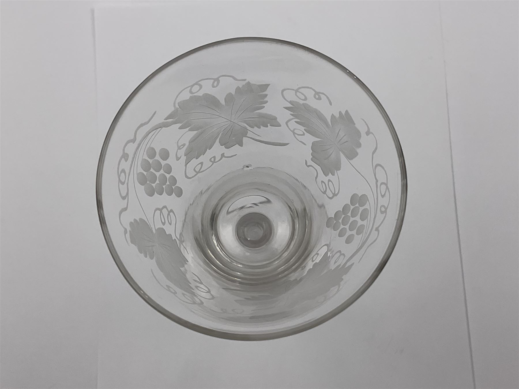Set of three 18th century style wine glasses, each with funnel bowl etched with fruit vine, upon a double series air twist stem and circular foot, H17cm