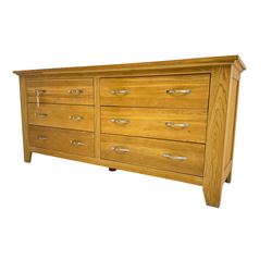 Contemporary wide oak straight-front chest, fitted with a bank of six drawers with chrome handles, on tapered feet