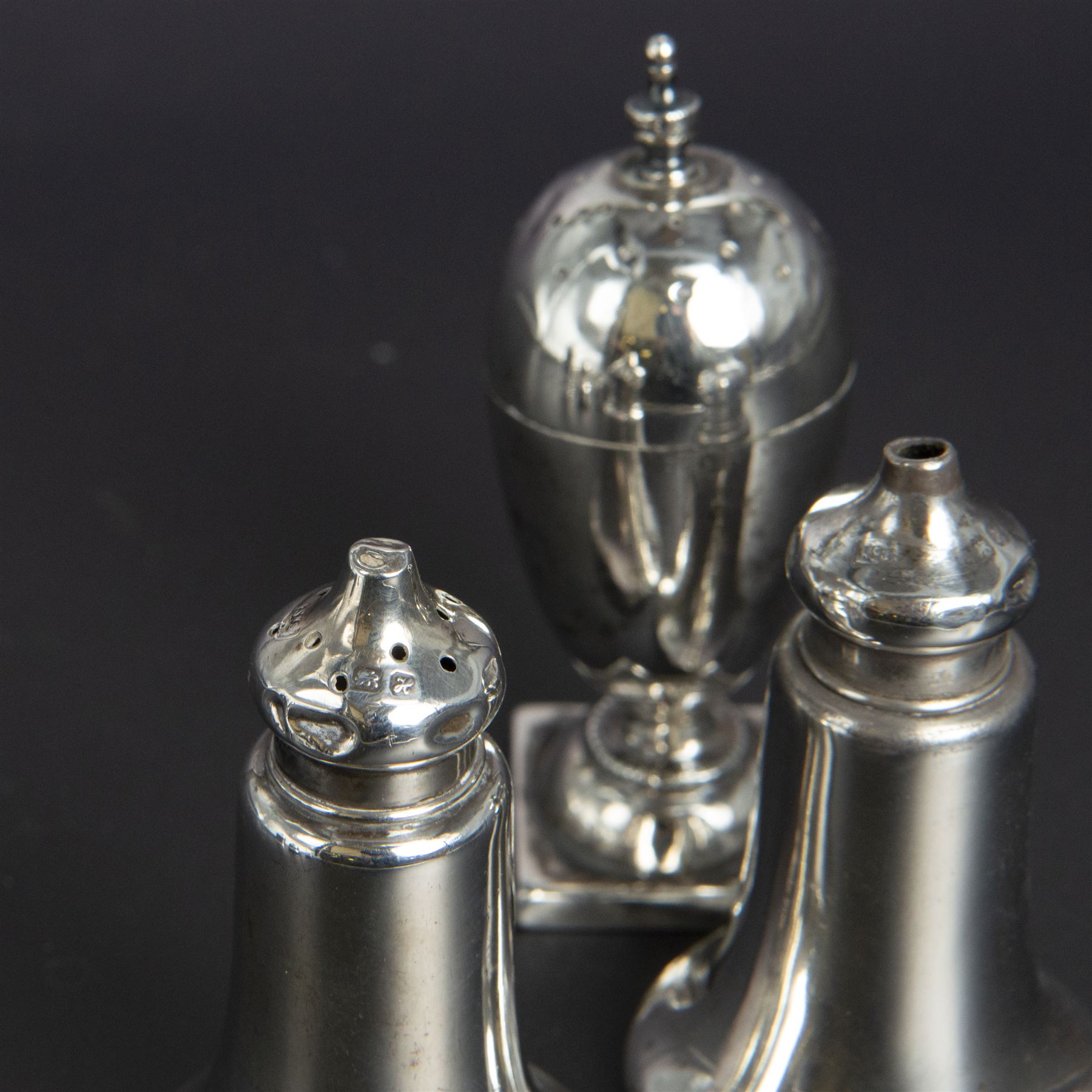 Group of silver cruets, including a pair of Edwardian conical shaped salt and pepper shakers and four other salt/pepper shakers, all hallmarked 