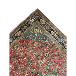 Persian Sarouk rug, red and blue ground, the field decorated with scrolling foliate and stylised plant motifs, the border decorated with floral panels