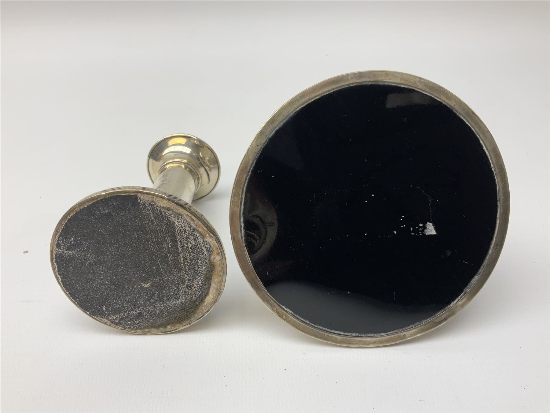 1920's silver mounted capstan inkwell, hallmarked Charles Boyton & Son Ltd, London 1929, together with an early 20th century silver mounted dwarf candlestick, hallmarked A J Pepper & Co, Birmingham 1918