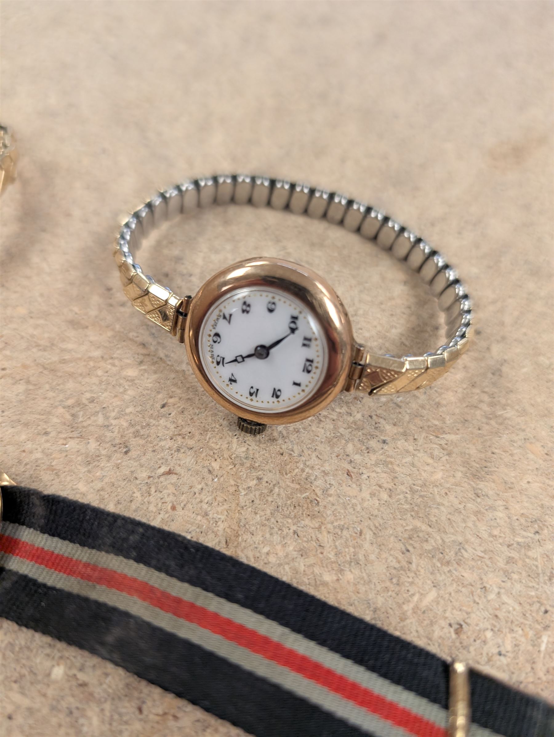Two ladies 9ct gold cased manual wind wrist watches, both on expanding base metal straps, together with a gentlemans 9ct gold cased wristwatch on canvas strap