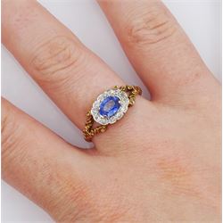 9ct gold oval sapphire and diamond cluster ring, with split design shoulders, London 1987, sapphire approx 0.60 carat