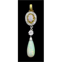 Gold and platinum opal and diamond pendant, the pear shaped opal cabochon suspending from a single old cut diamond of approx 0.20 carat and an opal and diamond cluster