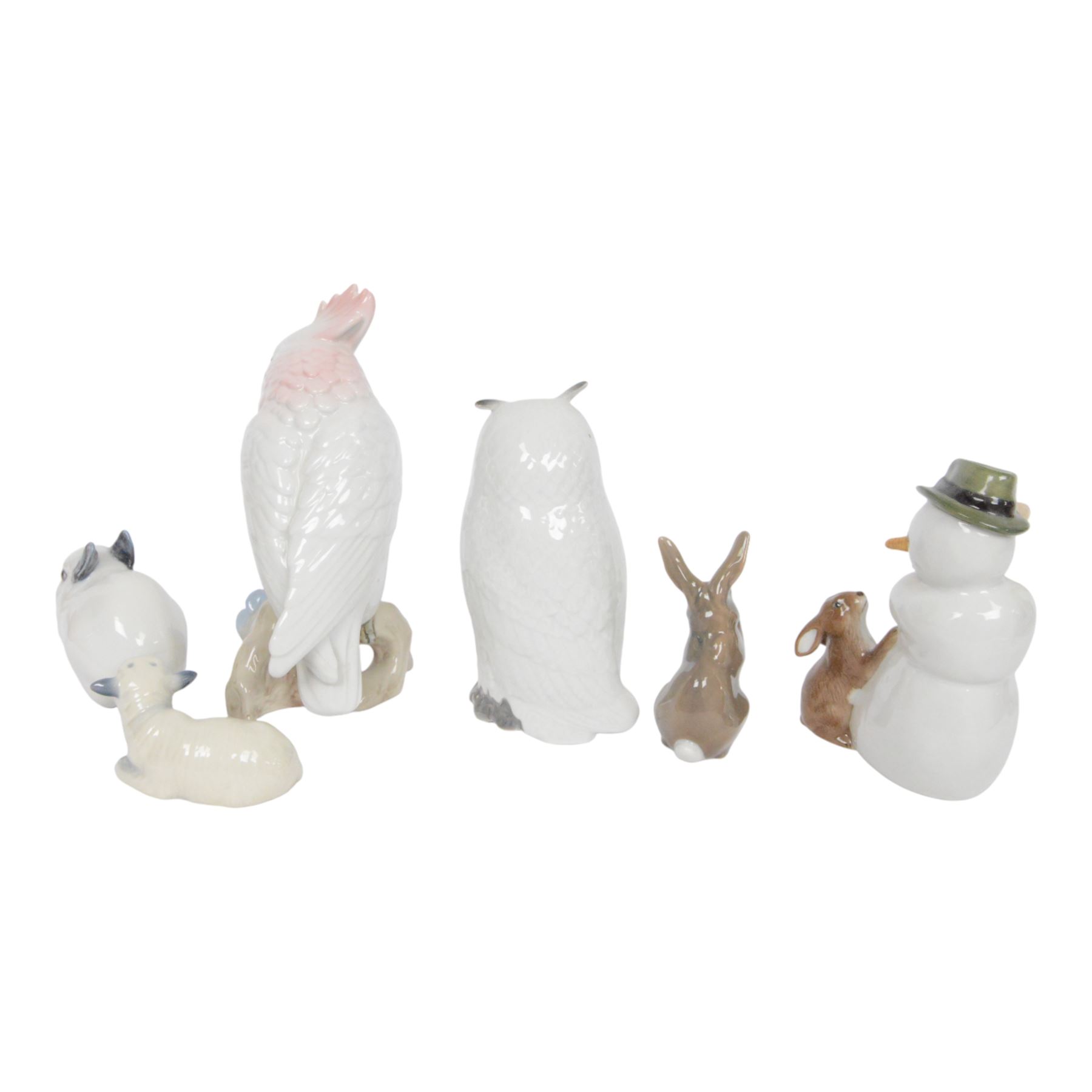 Royal Copenhagen, five figures including Owl 155, Snowman 017, Rabbit 154 etc, together with Royal Dux cockatoo