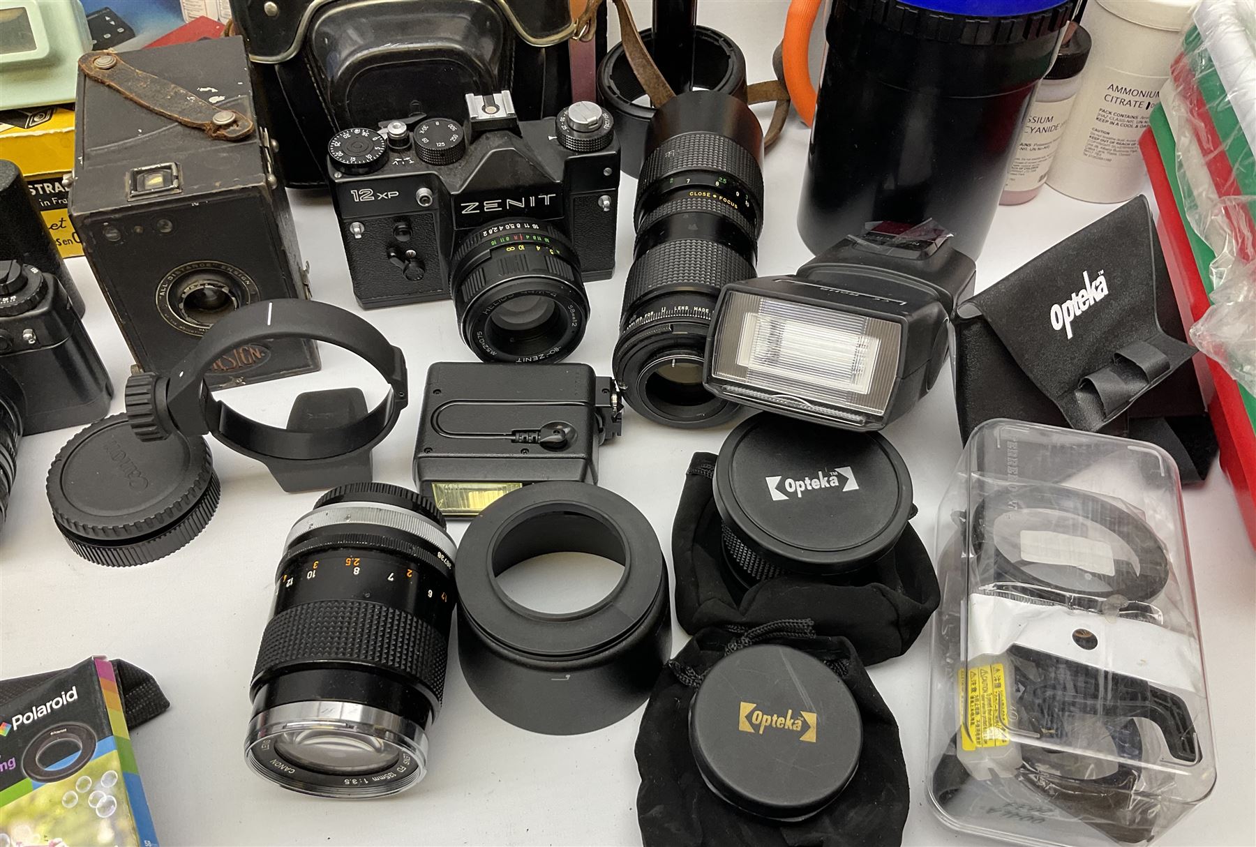 Vintage and later cameras, lenses, accessories and darkroom equipment including Zenit 12XP camera, Praktica BX20 camera fitted with 'Sigma Zoom Master 1:3.5-4.5 f=35-70mm' lens, Praktica LLC camera fitted with 'Carl Zeiss Jena Pancolar 1.8/50' lens, Canon Zoom Lens 'EF 100-300mm 1:5.6', various Jessop and other makers darkroom items including safelight (Red), universal duo tank, multi-mask enlarging easel etc, in three boxes