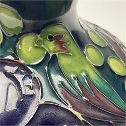 Moorcroft vase, of squat baluster form with fluted rim, decorated in the Finches pattern, in green and purple colourway upon dark blue/green ground, with printed marks beneath, H11cm
