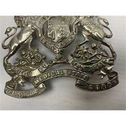 Victorian Volunteer Medical Staff Corps white metal helmet plate in the form of Victorian crowned Royal Arms with three part lower scroll for “VOLUNTEER MEDICAL STAFF CORPS”; three lug fittings to the reverse L8.5cm