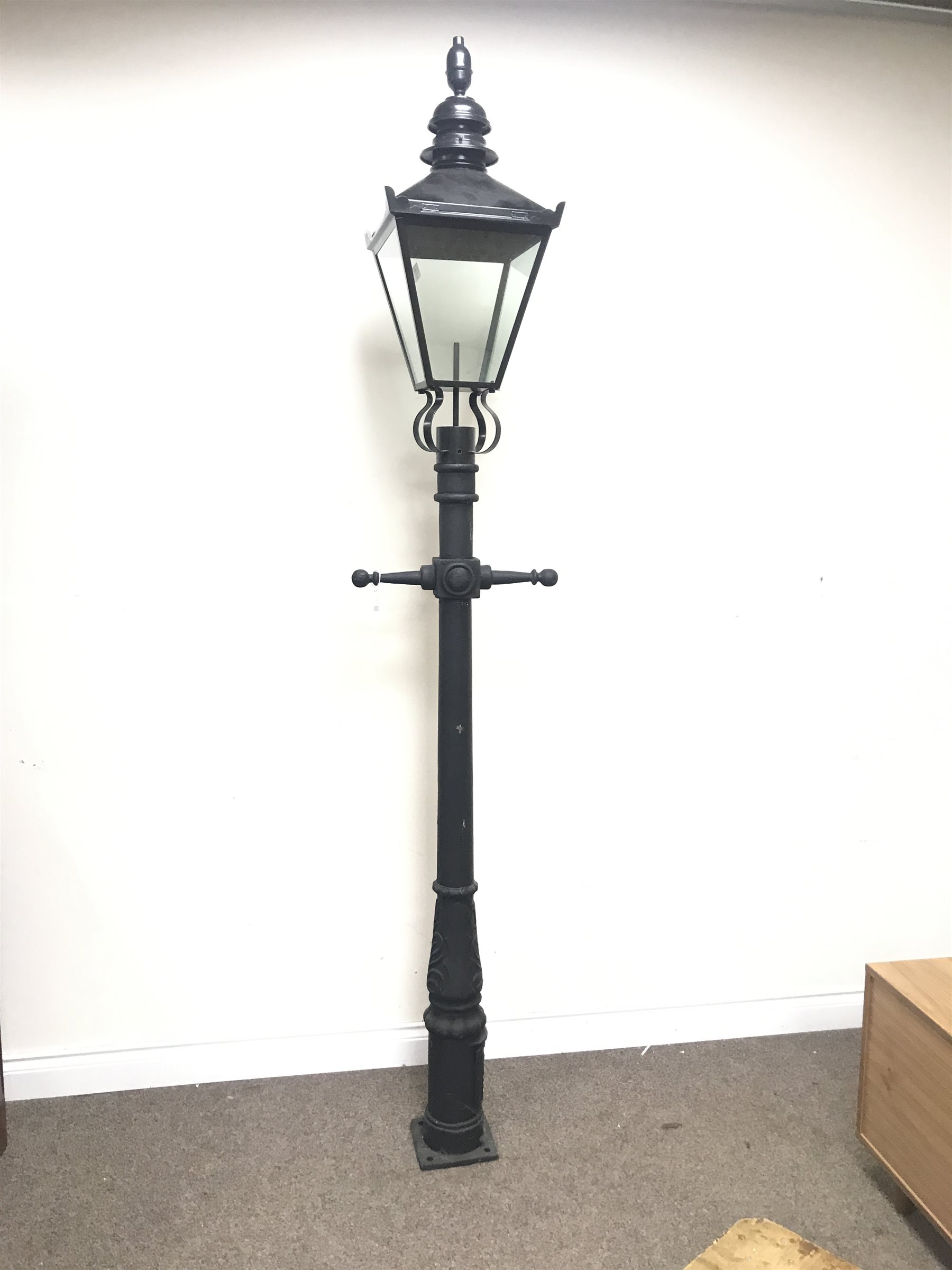 Victorian style cast iron street lamp post with glass lantern top