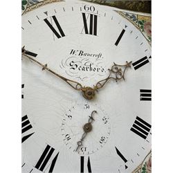 Thirty-hour oak cased longcase clock by  William Bancroft of Scarborough circa 1830, with a swan’s neck pediment, brass patera and three brass spire and ball finials, stepped break arch hood door flanked by plain pillars with brass capitals, trunk with a full length door and curved arch top, on a plain square plinth with bracket feet, painted break arch dial with roman numerals and quarter hour Arabic’s, date recorder (anti clockwise) and matching brass hands, arch painted with a rural scene depicting a ruined tower and cottage with depictions of flowers to the spandrels, dial pinned directly to a chain driven countwheel striking movement, striking the hours on a bell. With weight and pendulum. The Bancroft family were prodigious Scarborough clockmakers during the 18th and 19th century, William Bancroft is recorded as working in Newborough Street from 1820 onwards. 


