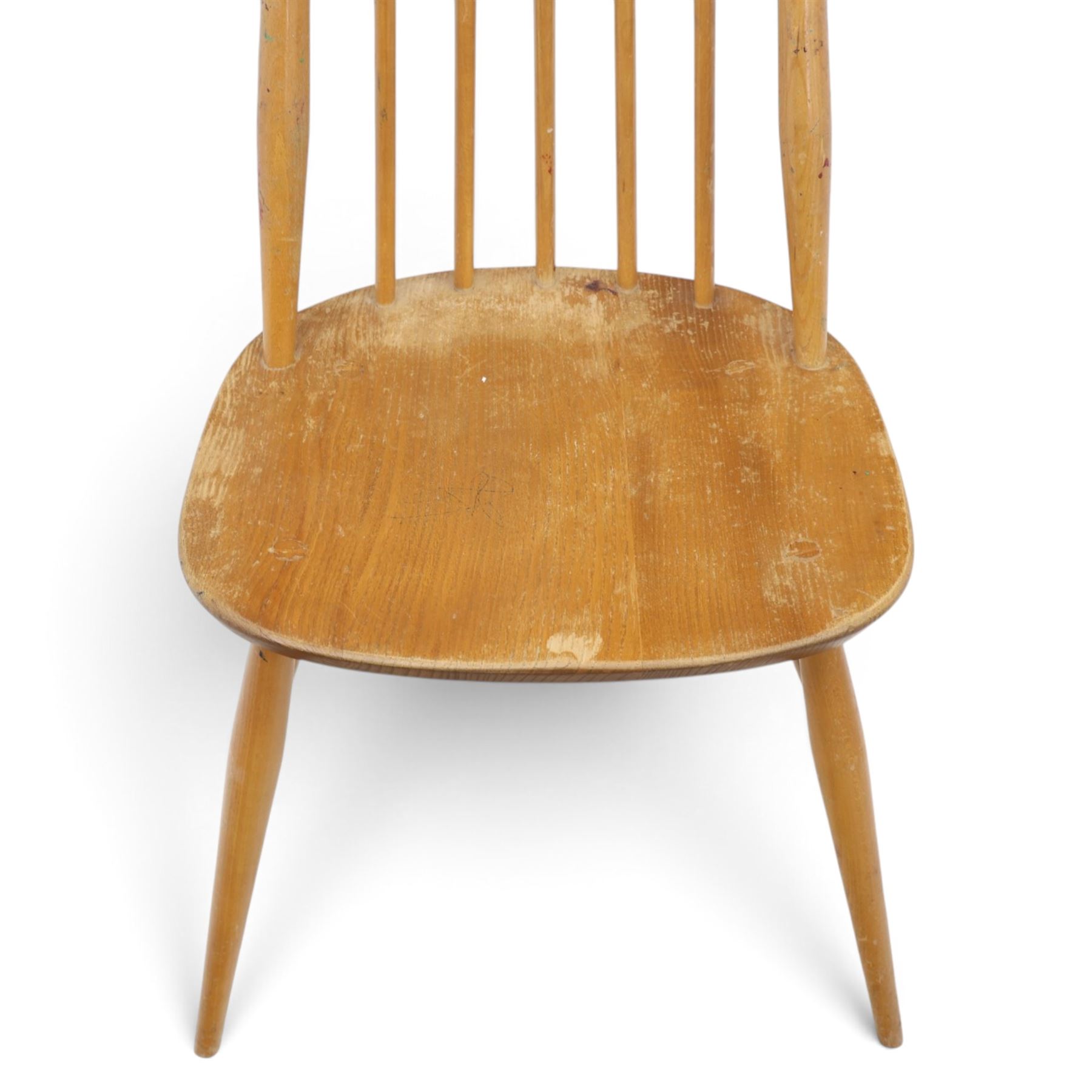 Ercol - 'Goldsmith' light elm set of four dining chairs, shaped cresting rail above seven spindles, dished seat raised on tapering supports with H-stretcher