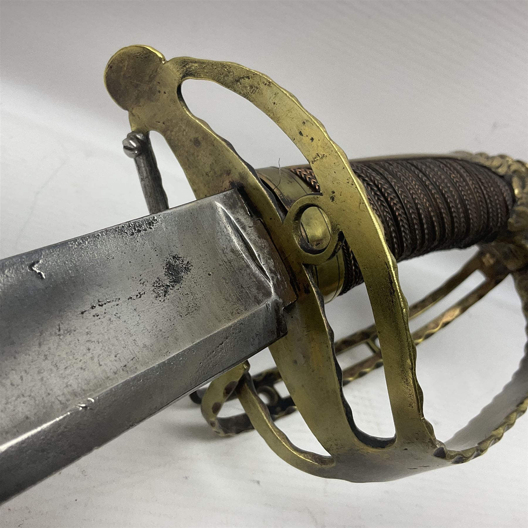 Late 18th century French 1st Empire Troupe a Pied Petit Montmorency Branch Tournante officer's sword, with 72.5cm slightly curving fullered blade, pierced brass hilt with lockable swivelling bar, fully wire-bound grip with lion head pommel, L88cm overall (no scabbard)