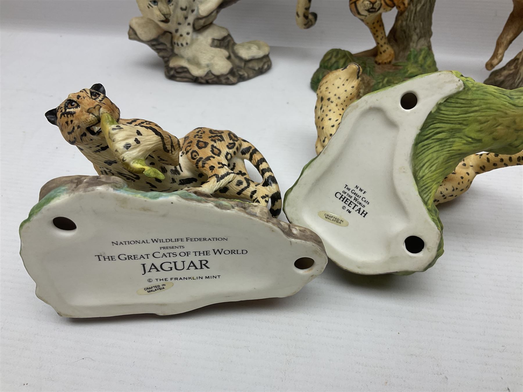 Ten Franklin Mint National wildlife Foundation Big Cats of the World figures to include, White Bengal Tiger, Jaguar, Cougar, Cheetah, Clouded Leopard etc, with display stand