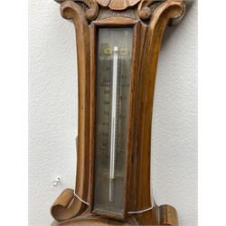 Early 20th century walnut cased aneroid barometer, the pediment carved with scrolls and shell, mercury thermometer