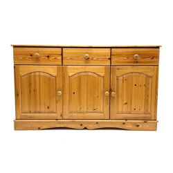 Solid pine sideboard, three long drawers above three cupboards enclosing shelving, raised on shaped plinth base 