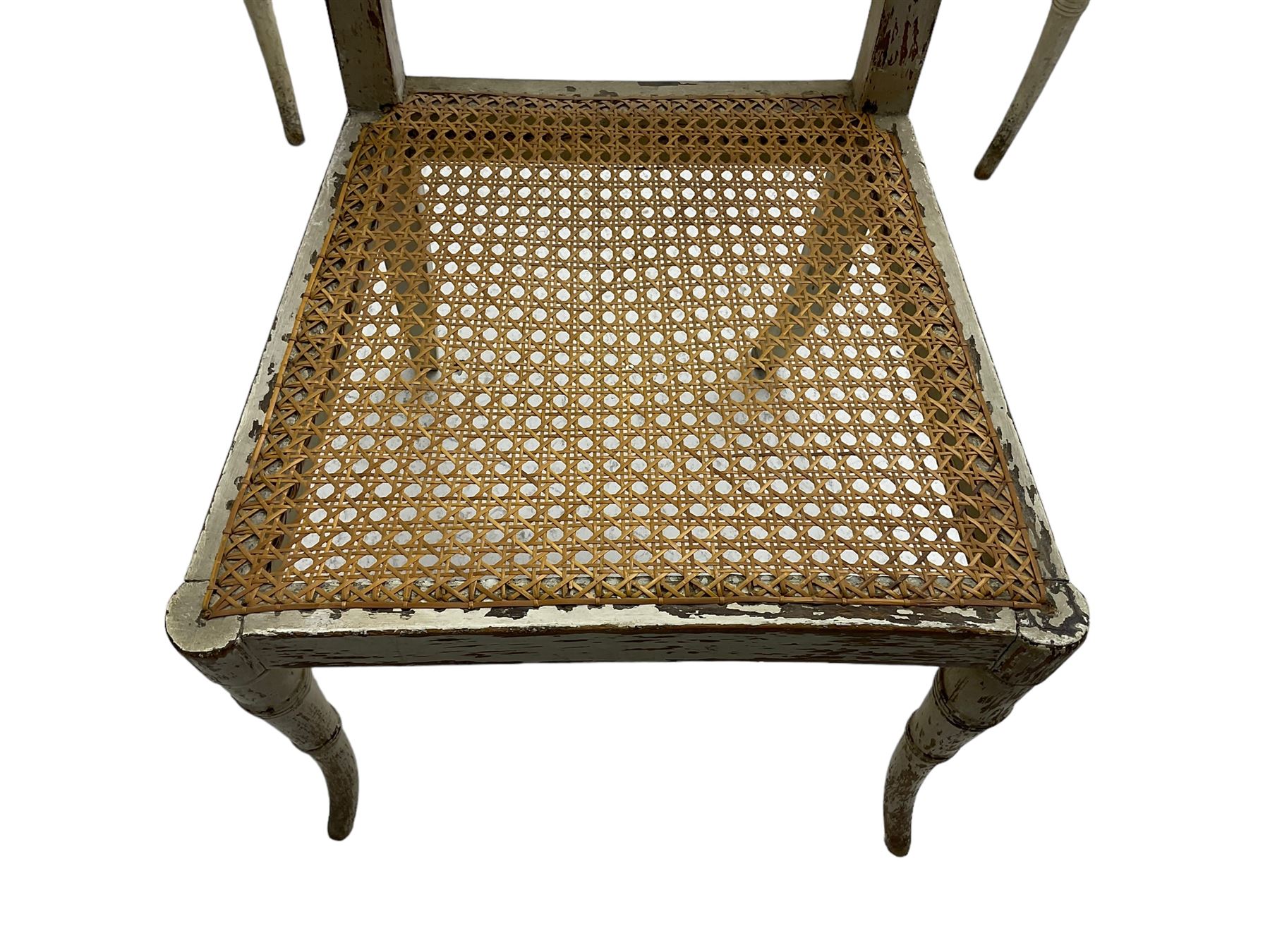 Collection of Regency dining chairs - set of four Regency painted beech dining chairs, with cane seat and back, on collar turned supports with splayed feet (W46cm, H84cm); a pair of Regency ebonised dining chairs (W47cm, H77cm); and a single Regency dining chair, the cresting rail painted with floral cornucopias and central putto vignette, X-frame back over cane seat, on collar turned front supports painted with foliage (W46cm, H84cm) (7)