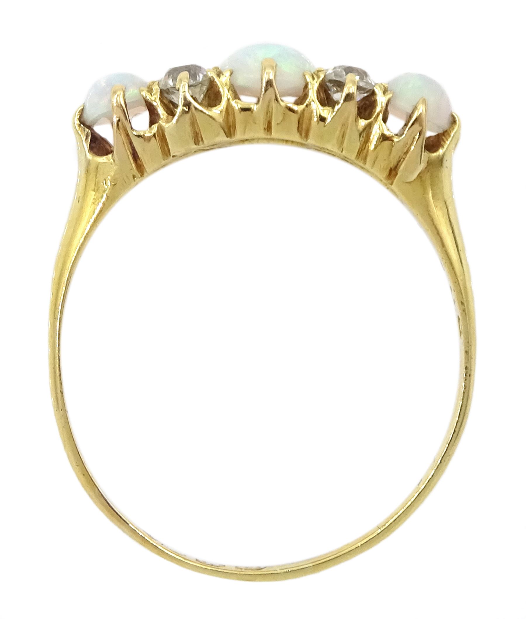 Early 20th century 18ct gold three stone opal, the centre stone set with two old cut diamonds either side, London 1913, total diamond weight approx 0.30 carat