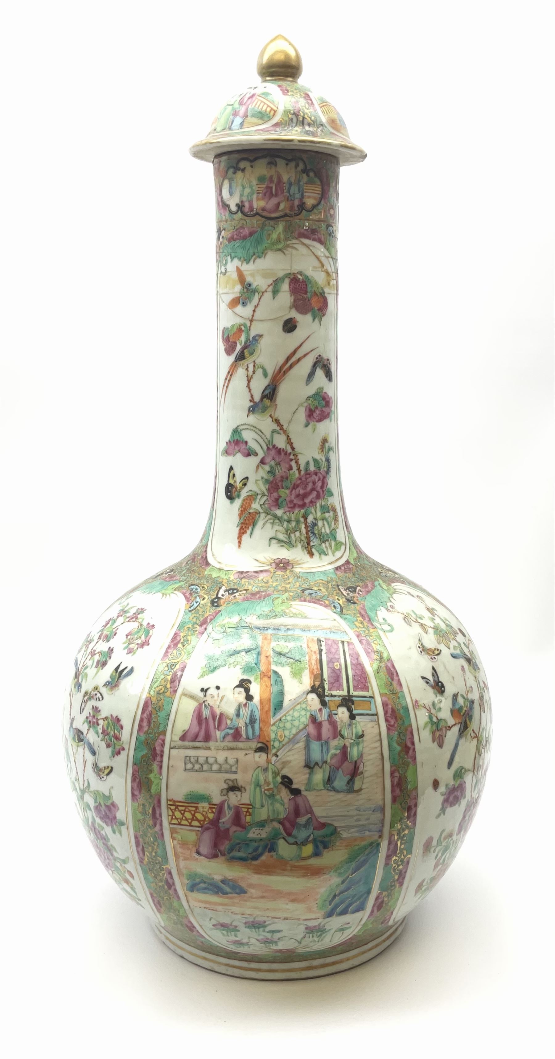 A 19th century Chinese Canton Famille Rose vase, of globular form with tall neck, and cover with finial, decorated with alternating panels of figural scenes, and birds and butterflies amongst blossoming and fruiting trees, with foliate surround against gilt, overall H57cm. 
