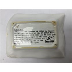 Two Fornasetti rectangular operatic posters ashtrays 'Norma' and 'Iris' decorated with black and white text with a gilt border edge, with printed mark beneath, H16cm