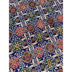Persian Tabriz indigo ground rug, overall Quba design, decorated with repeating stylised plant motifs and interlaced with trailing leaf motifs, repeating border within geometric guard stripes