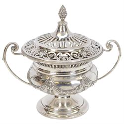 Early 20th century silver twin handled lidded bowl, of circular form with C scroll handles, the body embossed with floral swags, the pierced lid with pineapple finial, hallmarked Horace Woodward & Co Ltd, London 1911, H16cm