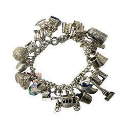  Silver charm bracelet, with twenty eight charms, including typewriter, rocking chair, carriage, cauldron, etc