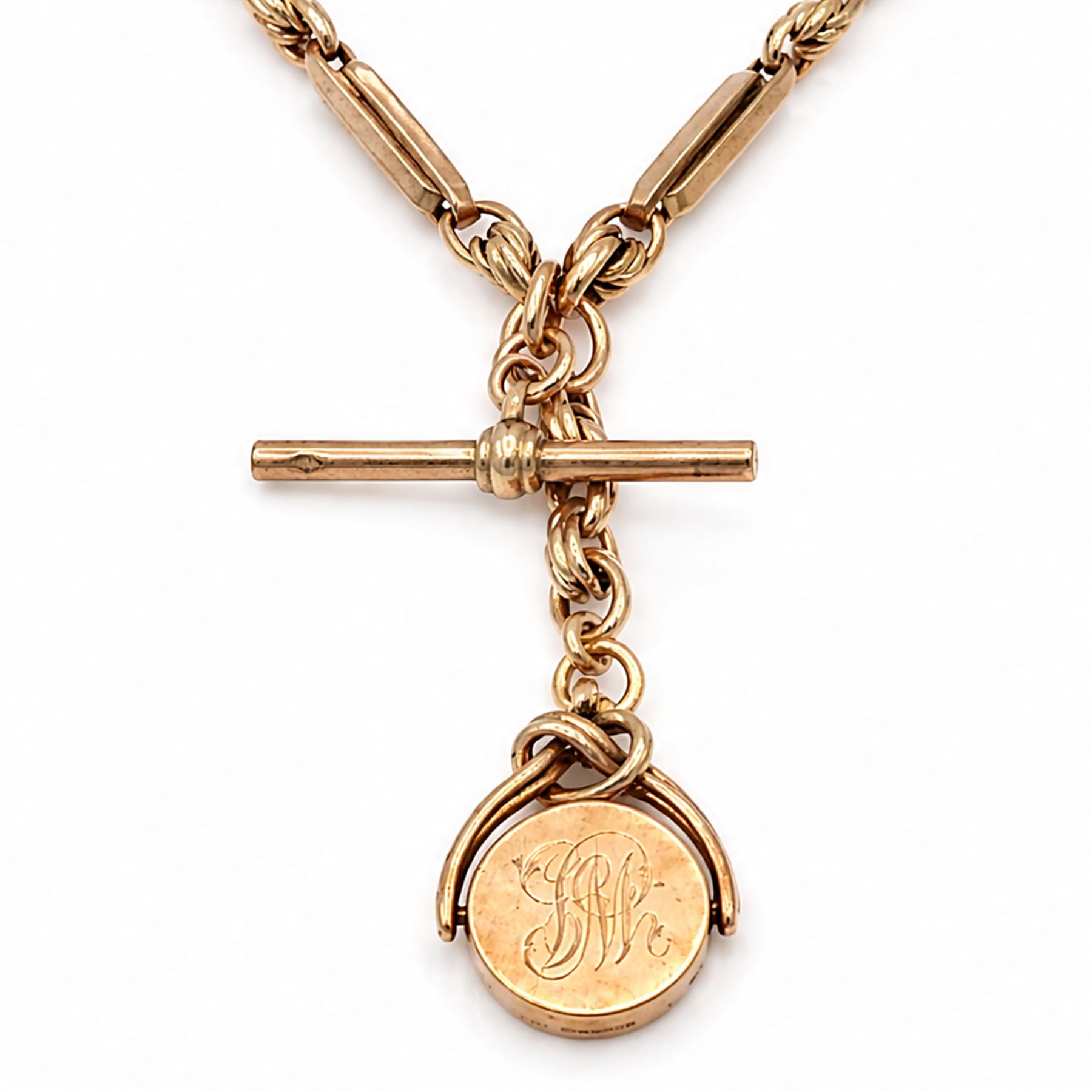 Early 20th century 9ct rose gold fancy link Albert chain, with rose gold swivel fob, monogrammed with initials, Birmingham 1923 