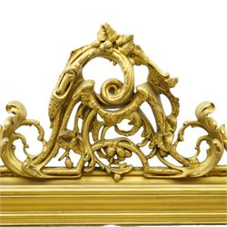 19th century Rococo Revival large gilt framed mirror, with bevelled rounded rectangular plate enclosed by a carved giltwood frame, surmounted by pierced scroll and foliate cresting, floral and scroll details to sides and corners