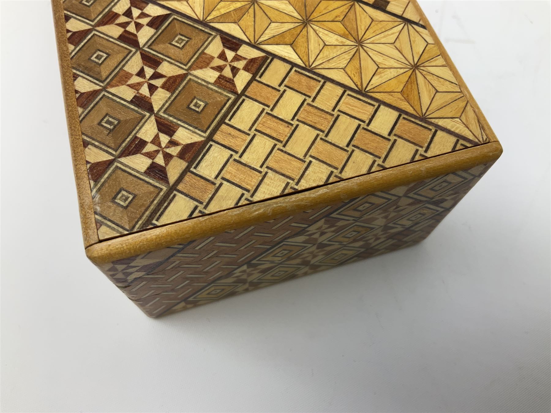 Japanese parquetry puzzle box L12cm; another Japanese puzzle box with marquetry top of Mount Fuji; eleven graduated Chinese figures including immortals; and Chinese figure of a lady standing on a hardwood base next to a horn table (14)