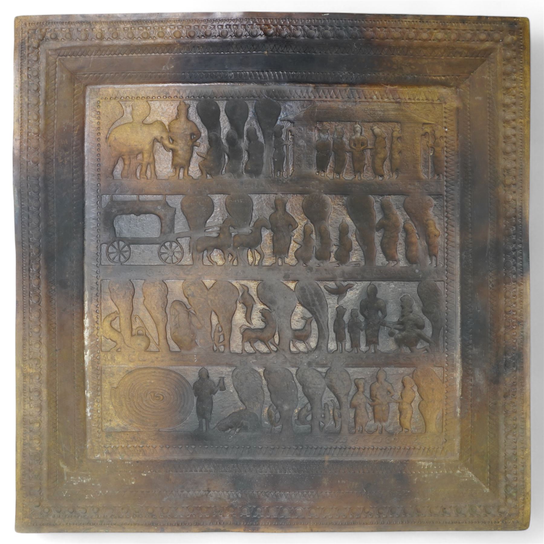 South Indian square brass plaque embossed with figures, animals, trees and buildings within a floral border 61cm 