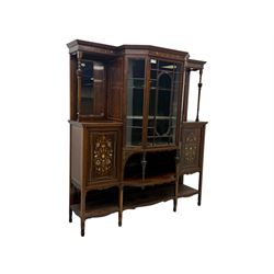 Victorian hardwood and inlaid display cabinet, central breakfront glazed display with astragal glazing and mirror back, flanked by mirrored alcoves with turned supports, below foliate and scrolling marquetry panels enclosing cupboard doors, shaped open shelves with turned supports beneath, on tapered and spade feet