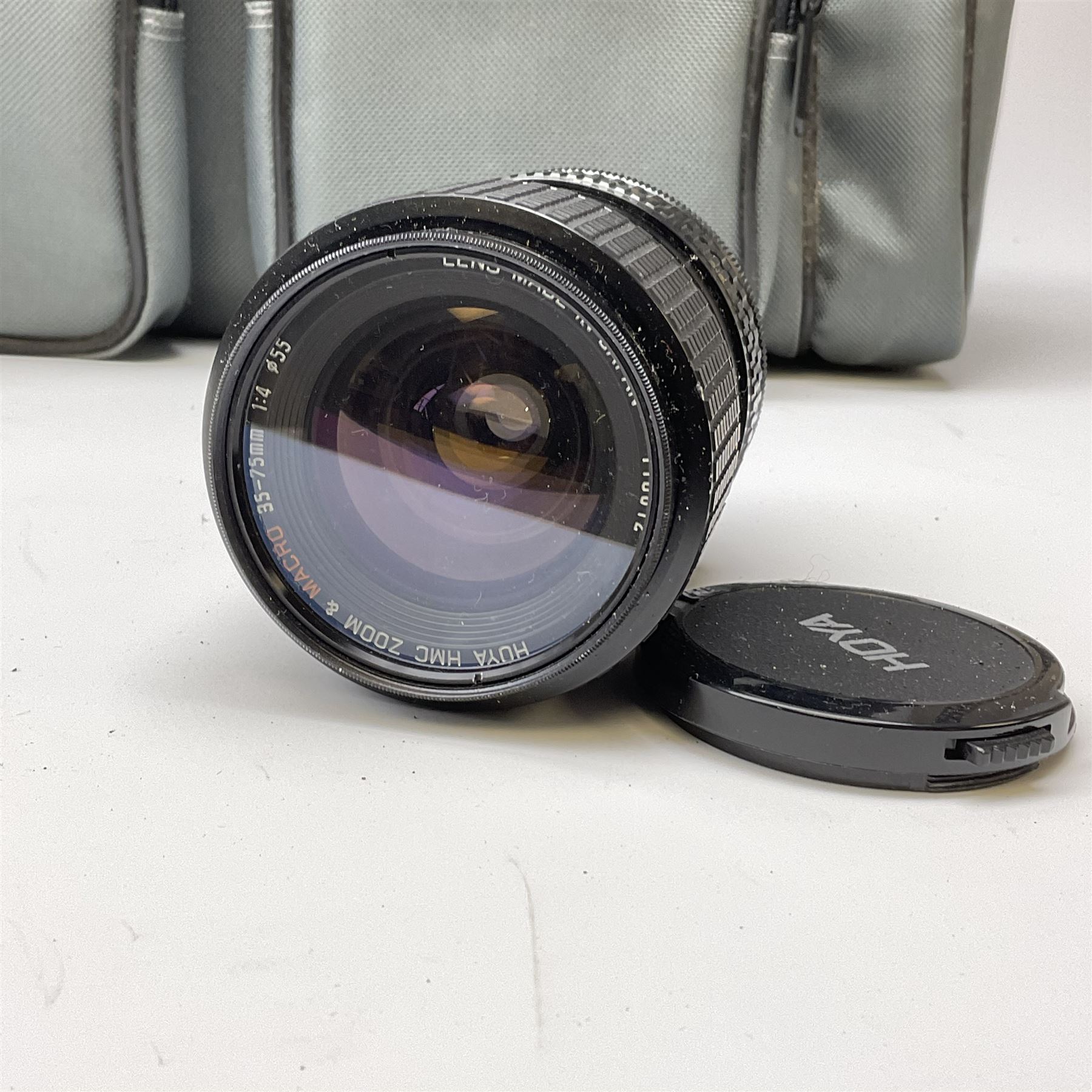 Canon AE1 camera, 'no. 4403757', fitted with Canon 'FD 50mm 1:1.8' lens, Hoya 'HMC Wide-Auto f24mm 1:2.8' lens and various other lenses and camera accessories, housed in a soft carry bag