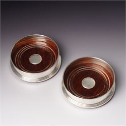 Pair of Elizabeth II silver bottle coasters with turned wooden bases D12cm, Birmingham 199...