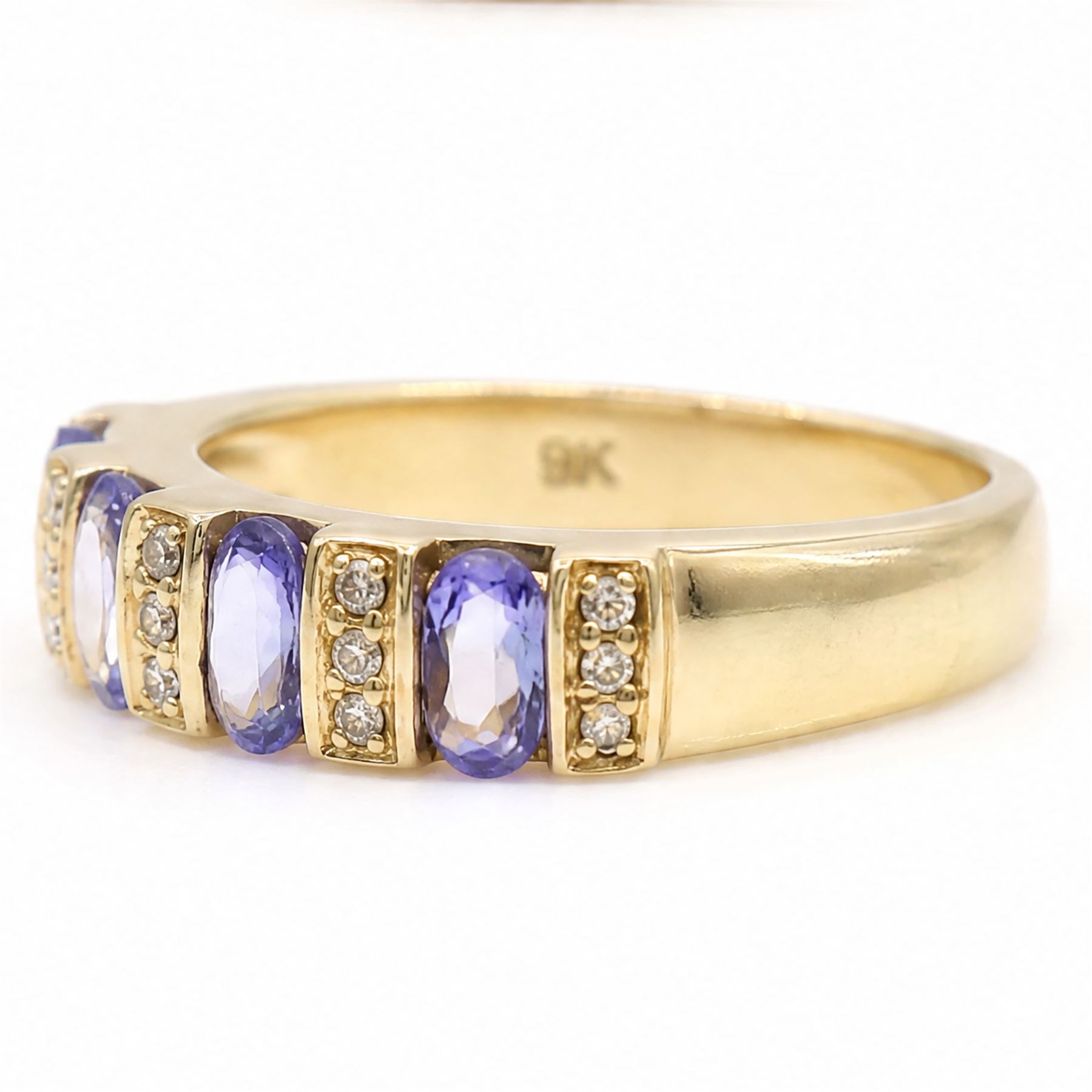 9ct gold tanzanite and diamond half eternity ring, four oval cut tanzanite's, each spaced by three single cut diamonds, hallmarked