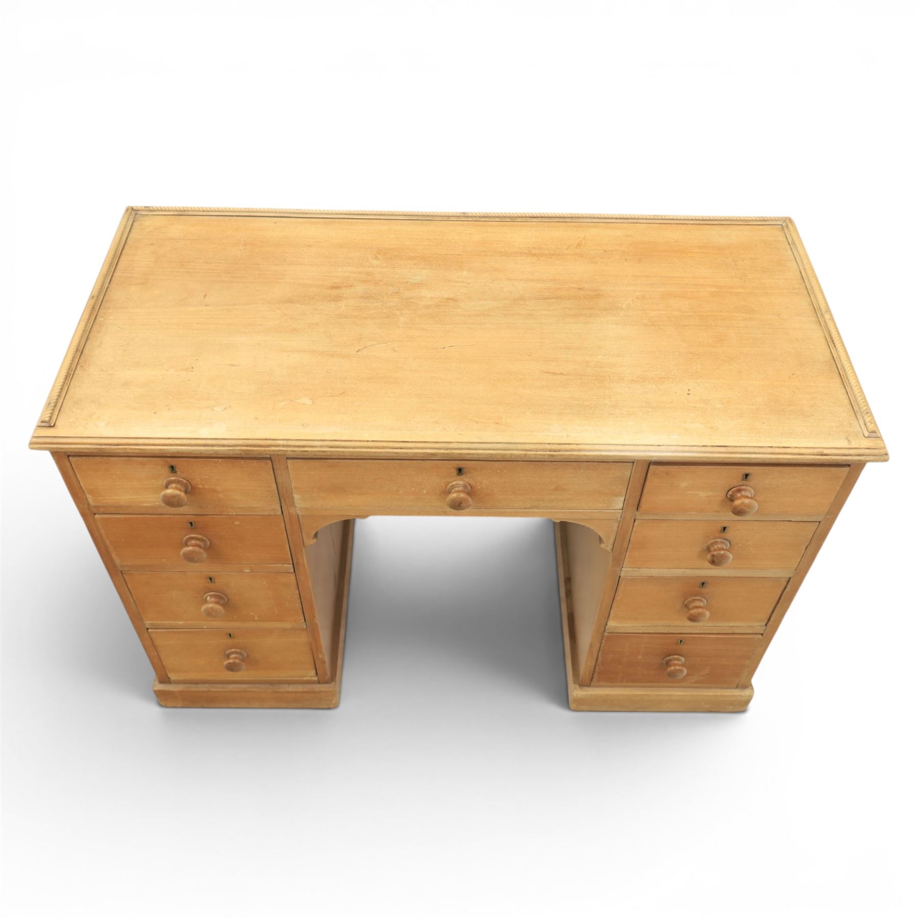 20th century ash twin pedestal desk, gadroon galleried top, twin bank of graduated drawers, plinth base