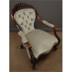  Victorian walnut open armchair, cresting rail carved and pierced with floral and scrolled leaf decoration, down swept arms with scroll terminals, arm supports and cabriole feet with flower head carvings, upholstered in buttoned velvet, wide serpentine seat, W68cm  