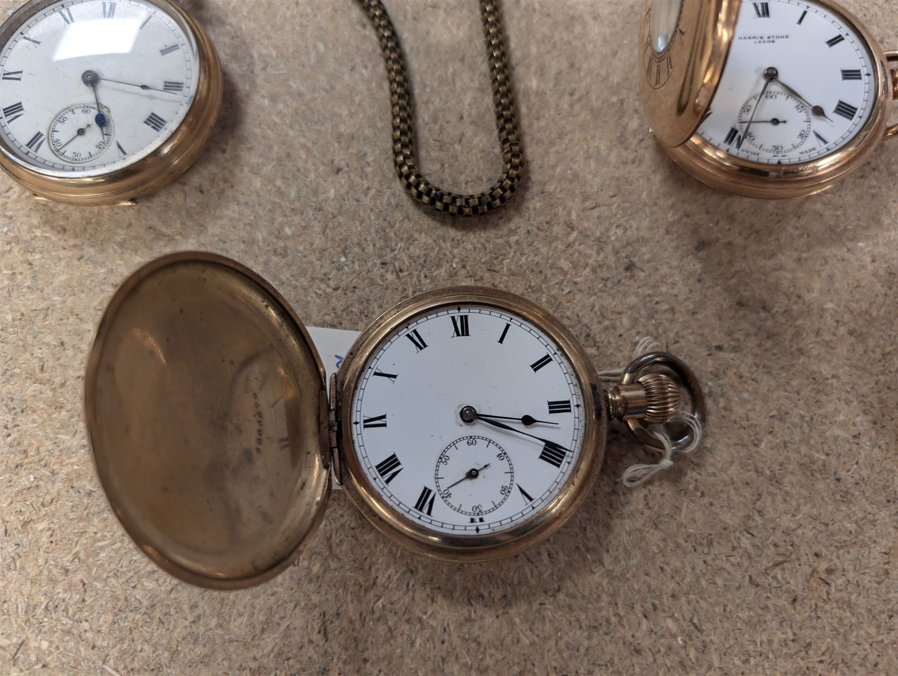 Four early 20th century gold-plated keyless pocket watches, three by Harris Stone Leeds, Waltham and Elgin and two gold-plated watch chains
