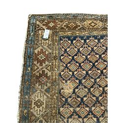 Caucasian indigo ground rug, the field decorated with geometric motifs within geometric pattern borders 