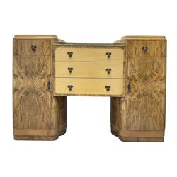 Early 20th century Art Deco twin pedestal sideboard, the pedestals fitted with single drawer over single cupboard enclosing shelf, flanking three central drawers with a figured band 