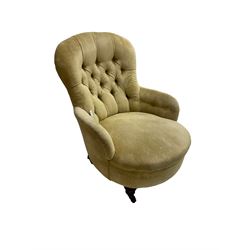 19th century armchair, upholstered in button pale yellow fabric with sprung seat, raised on turned feet with brass and ceramic castors