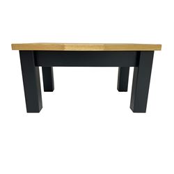 Oak rectangular coffee table, raised on square ebonised supports