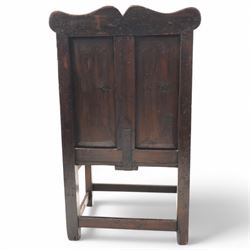Early 18th century oak open armchair, high back with two recessed panels beneath scrolled cresting rail, curved arms and box seat, raised on square-section supports united by stretchers