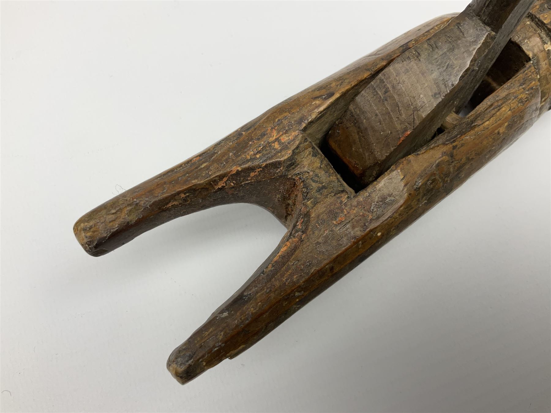Rare primitive treen lever action nutcracker, probably late 17th/early 18th century, carved in the form of a man, with old collector label to side inscribed 'A Nutcracker XVI Century', H18cm