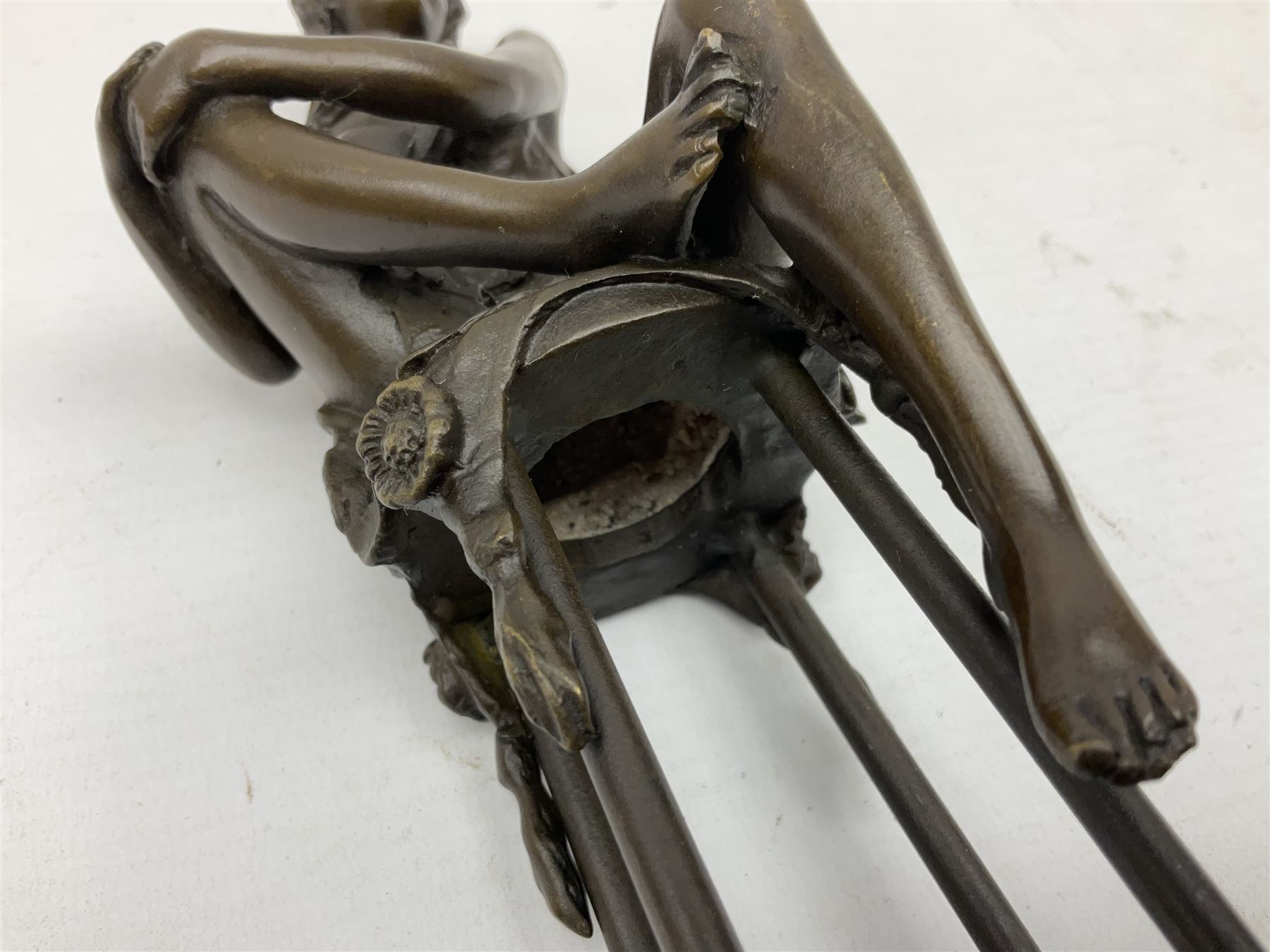 Art Deco style bronze modelled as a female figure, holding her knee, seated upon a chair, after 'Pierre Collinet', H28cm