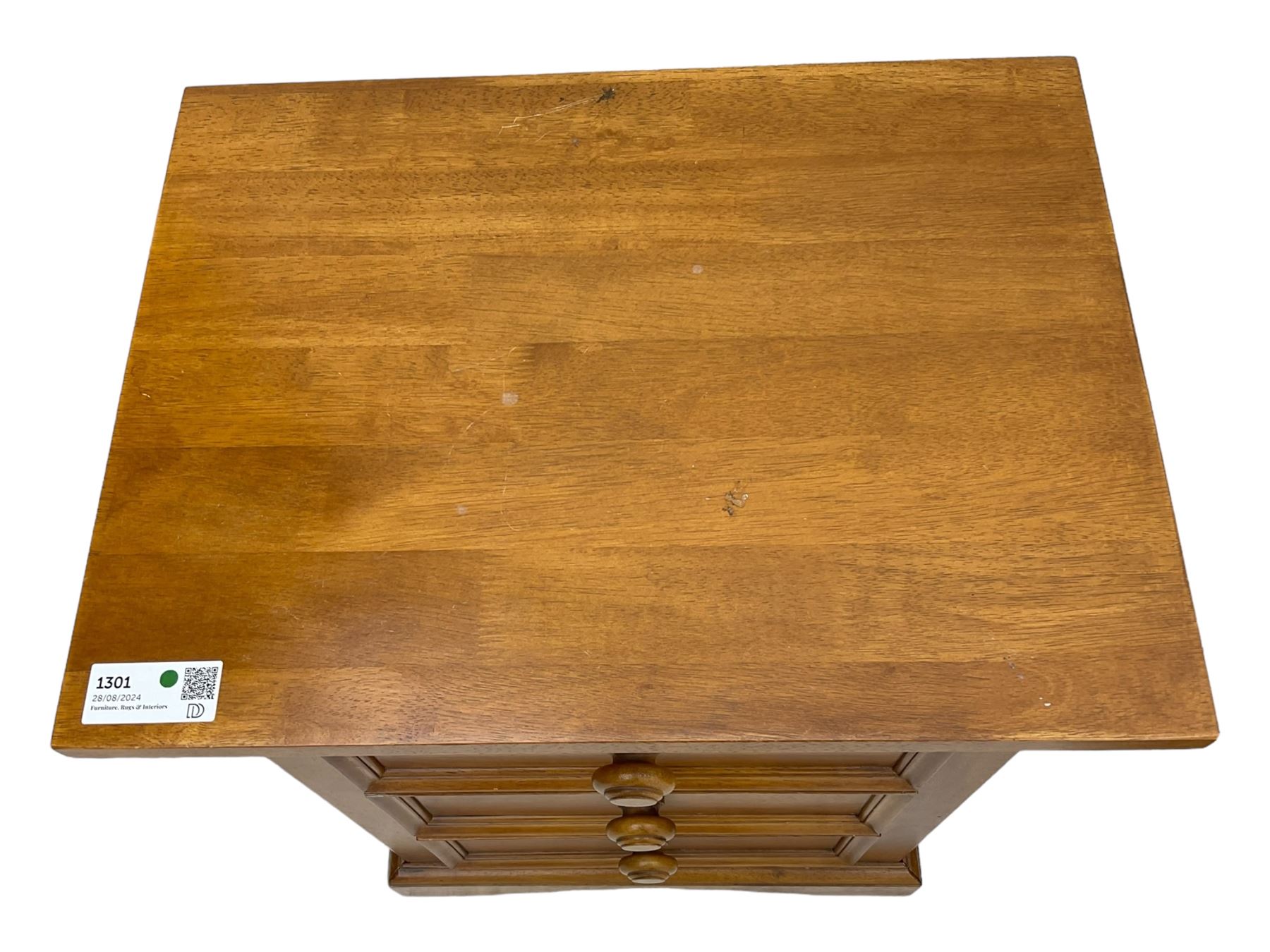Pair of contemporary cherry wood bedside chests, rectangular top and projecting moulded cornice over three drawers, on plinth base with shaped apron