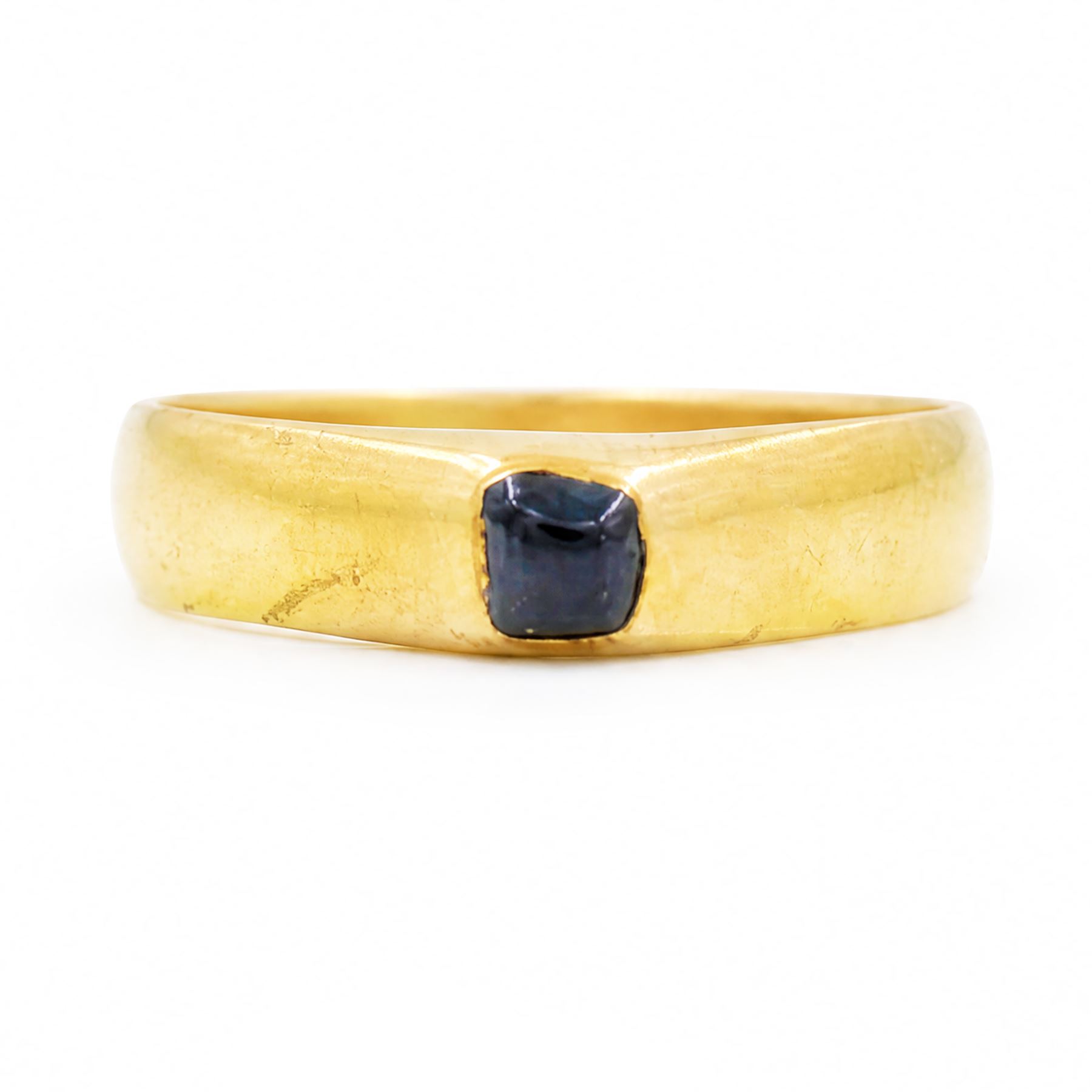 Medieval gold sapphire stirrup ring, circa. 1150-1500, the hoop of ‘D’ shaped cross-section, with raised triangular shaped bezel centred at the apex with a cabochon sapphire