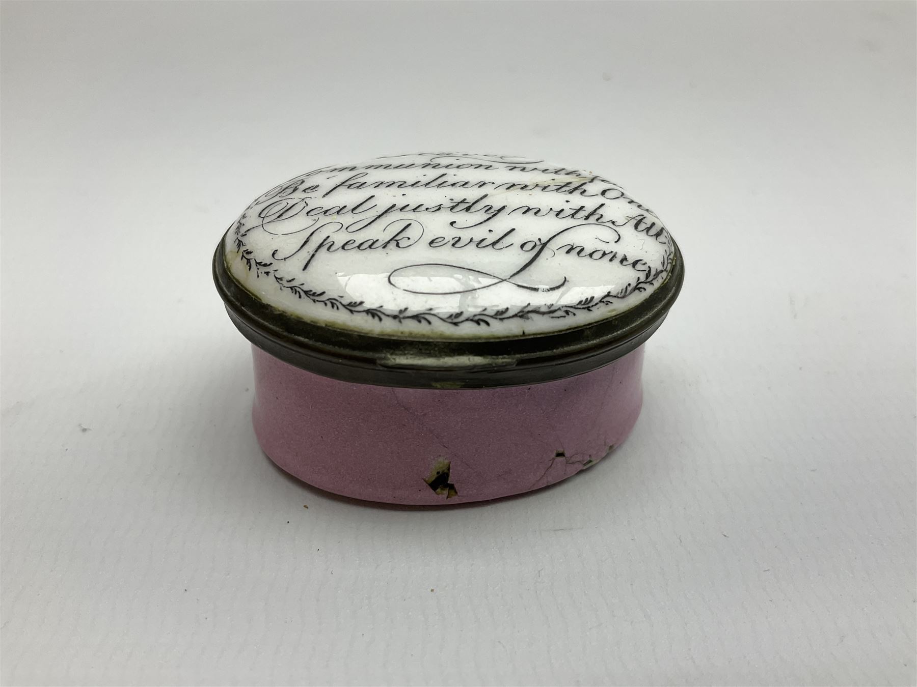 Late 18th century Staffordshire enamel patch box, of oval form with pink base, the hinged cover inscribed 'Have Communion with few, Be familiar with One, Deal justly with All, Speak evil of none' upon a white ground, opening to reveal mirror beneath, W4cm