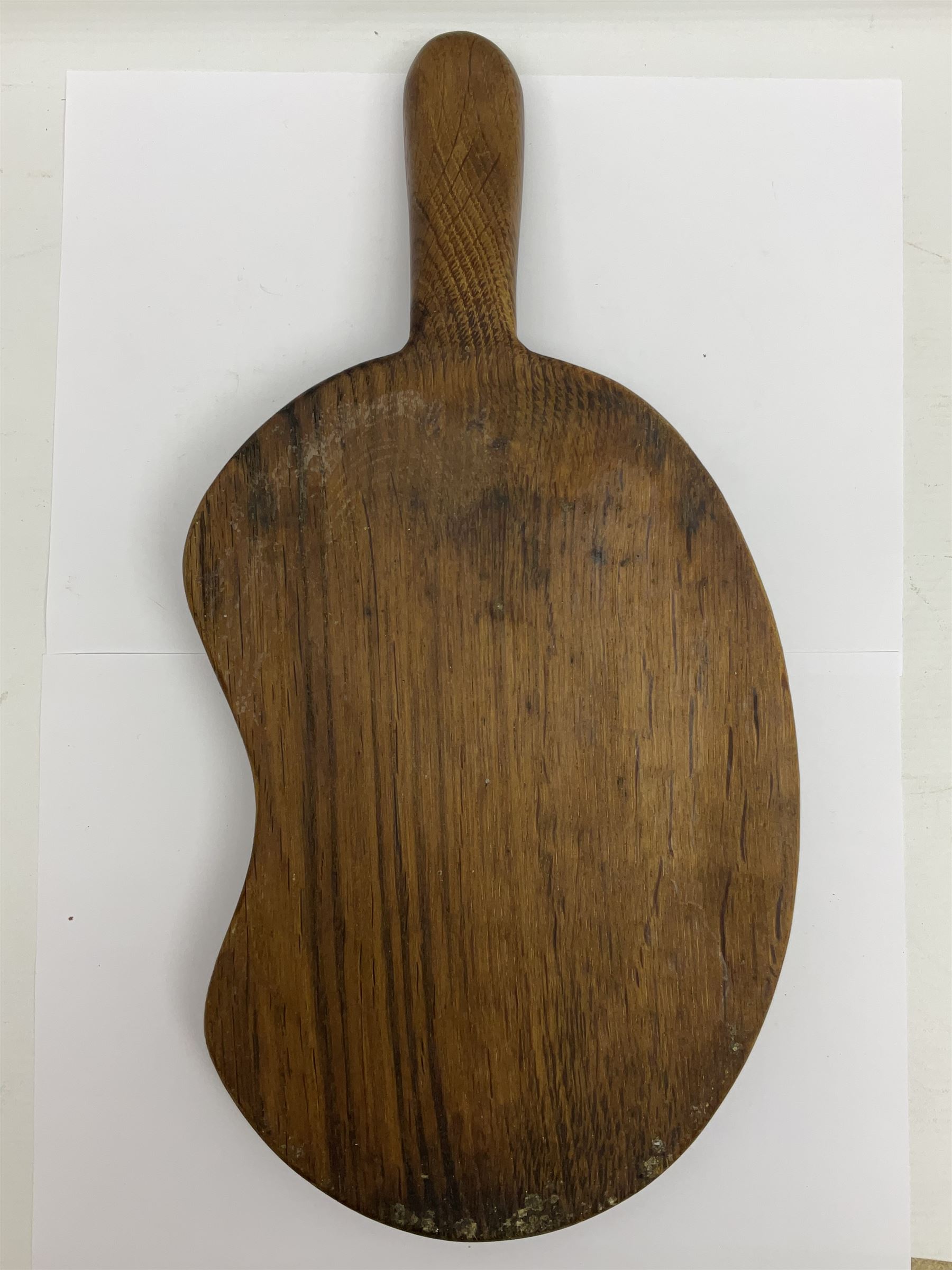 Mouseman - oak kidney-shaped cheeseboard, the handle caved with mouse signature, by the workshop of Robert Thompson, Kilburn 